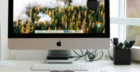 Free Stylish home office workspace featuring a computer setup with accessories. Stock Photo
