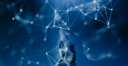 Free A robotic hand reaching into a digital network on a blue background, symbolizing AI technology. Stock Photo