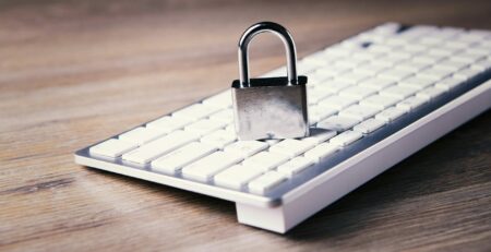 a computer keyboard with a padlock on top of it